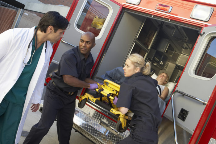 Paramedics loading patient into ambulance